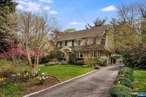 a view of house with yard and green space