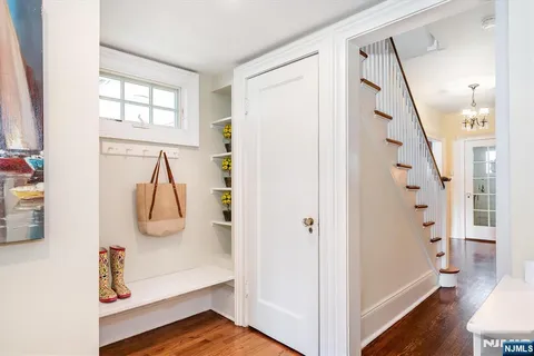 a view of a livingroom with wooden floor and stairs