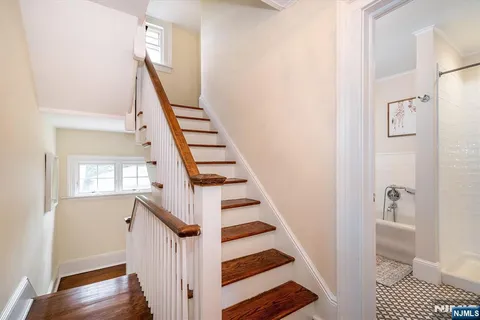 a view of an entryway with wooden floor and staircase