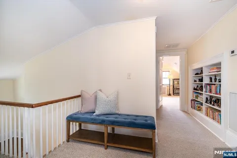 a view of living room with furniture and book shelf