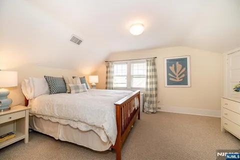 a spacious bedroom with a bed and a window