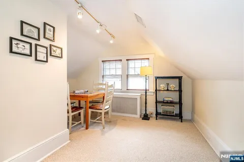 a view of a workspace with furniture and windows