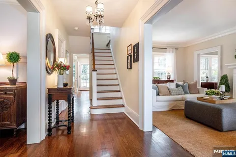 a view of a living room and entryway with wooden floor