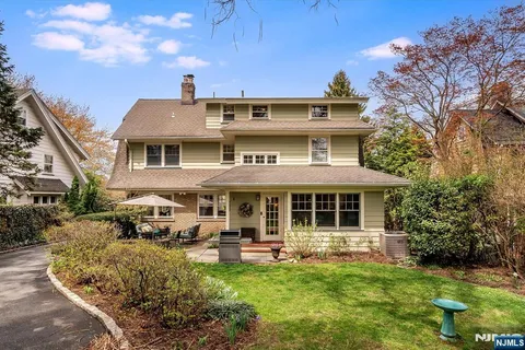 a front view of a residential apartment building with a yard