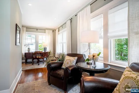 a living room with furniture and large windows