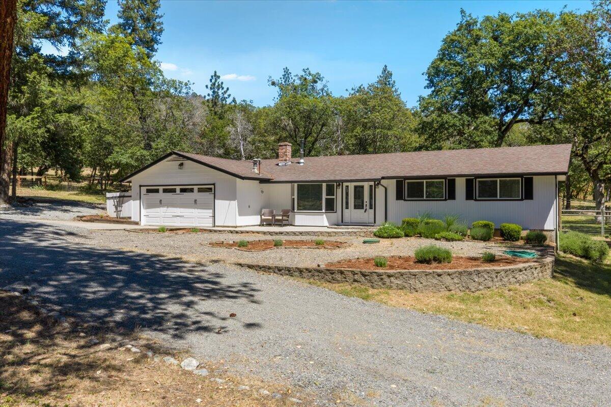 324 China Gulch Road Jacksonville, OR 97530 - Photo 3 of 45 a house with trees in the background