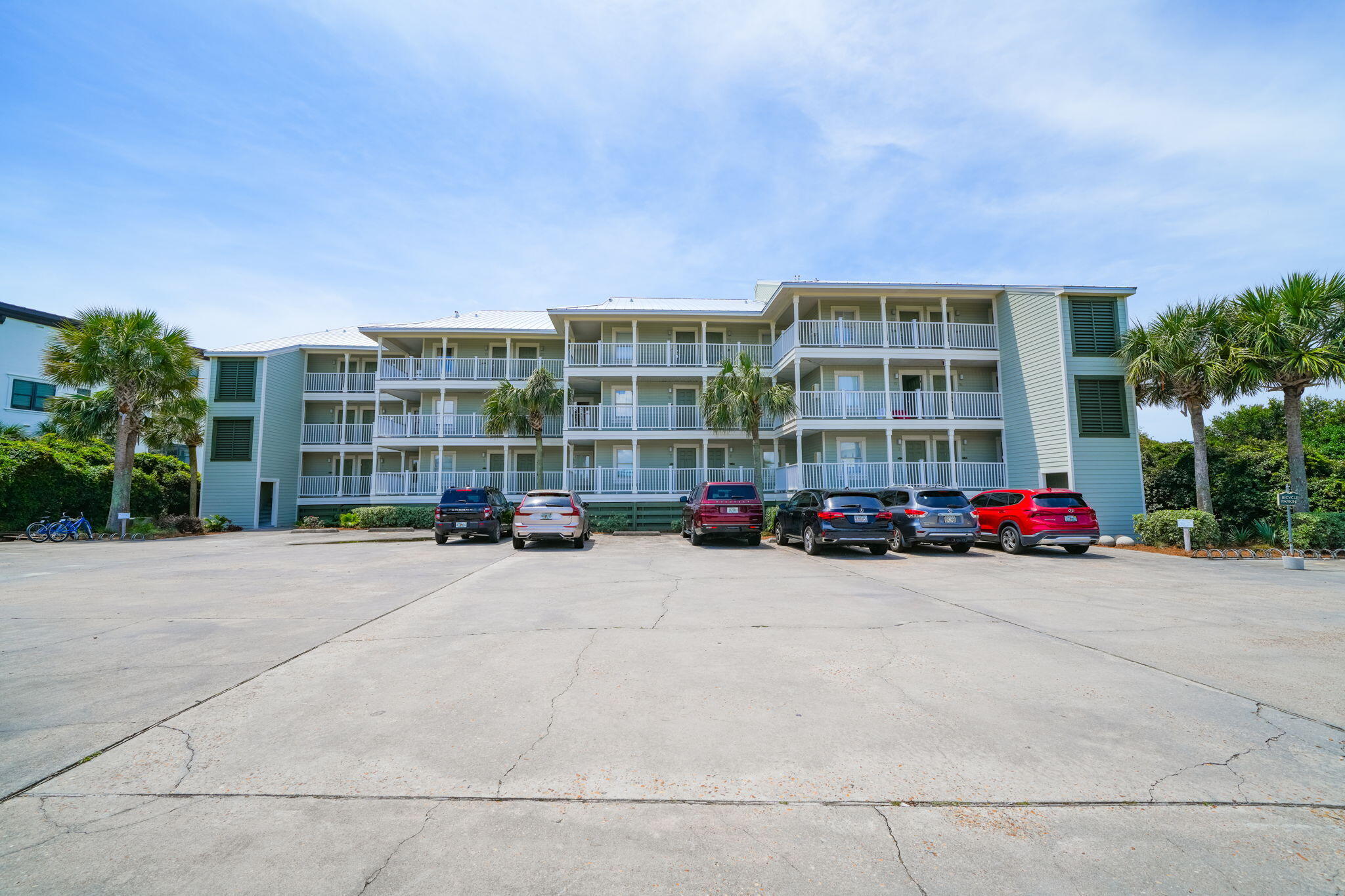 8294 East County Highway 30A, Unit 1 Inlet Beach, FL 32461 - Photo 42 of 45 a tall buildings with trees in front of it
