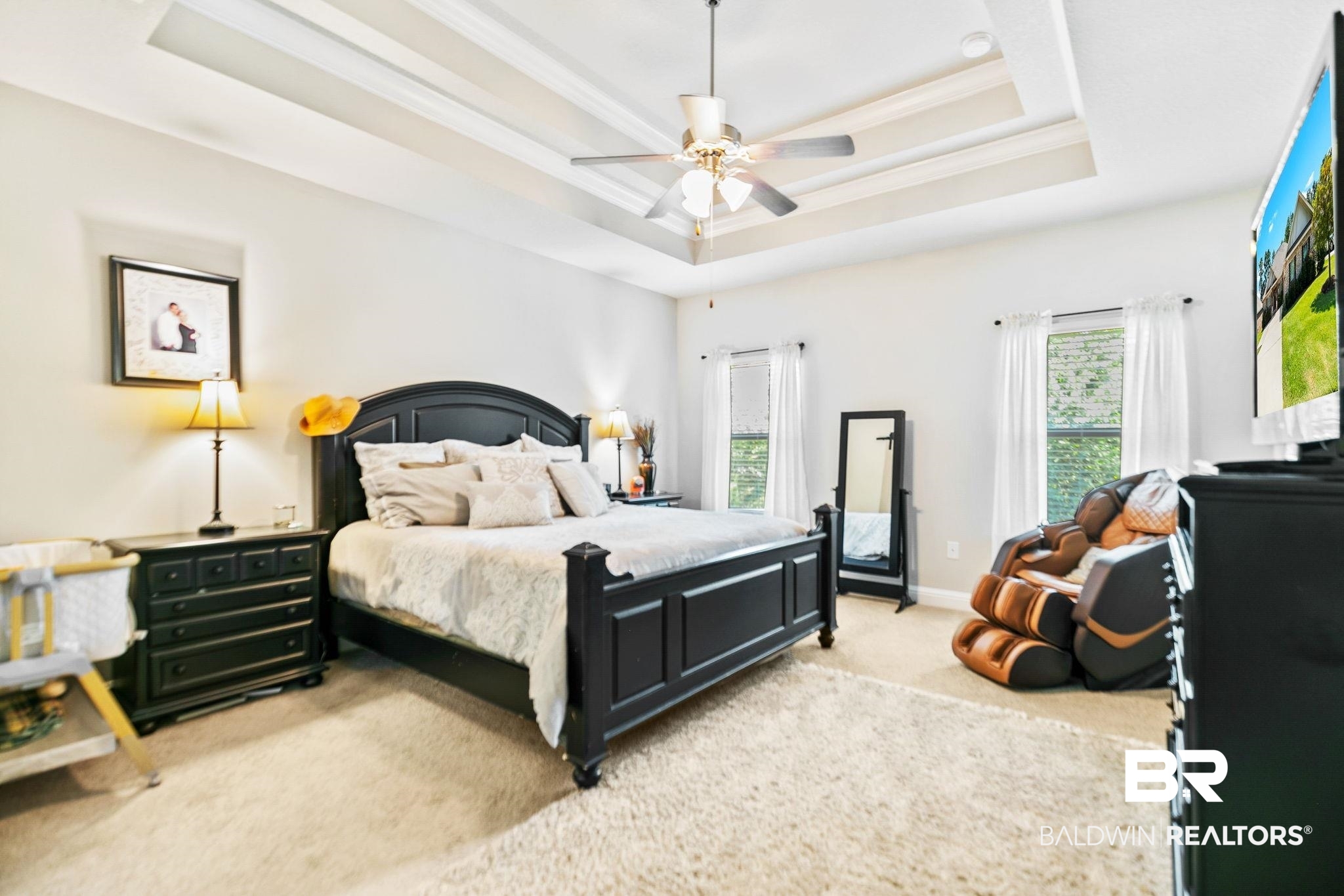 31402 Hoot Owl Road Daphne, AL 36527 - Photo 13 of 43 Bedroom featuring crown molding, light carpet, ceiling fan, and a raised ceiling