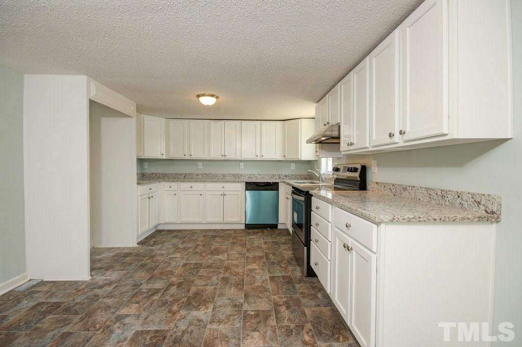 2959 Federal Road Benson, NC 27504 - Photo 3 of 20 a kitchen with a sink a stove top oven and cabinets