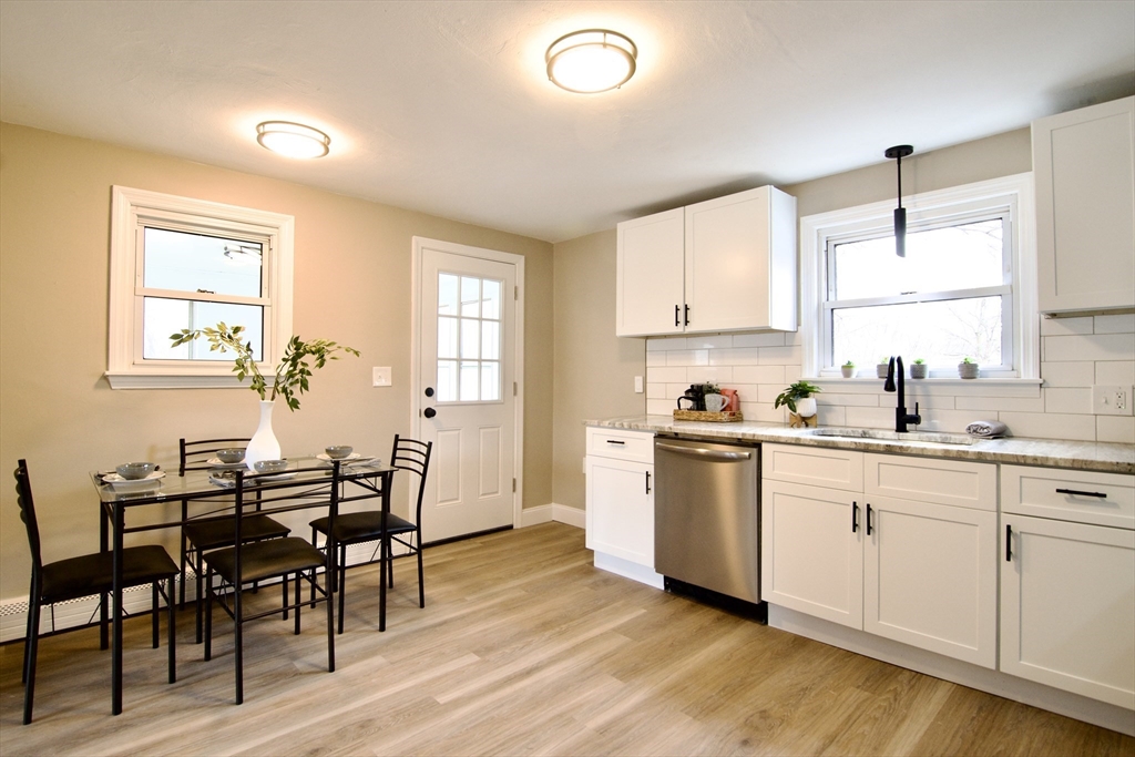 1295 Bay Street Springfield, MA 01109 - Photo 11 of 42 a kitchen with a table chairs sink and cabinets