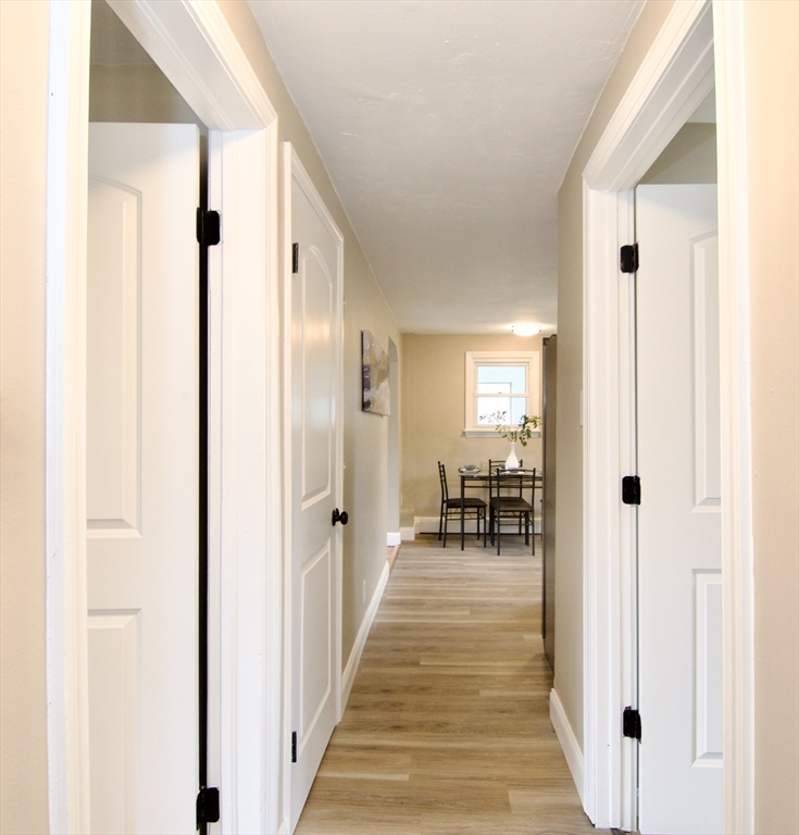 1295 Bay Street Springfield, MA 01109 - Photo 21 of 42 a hallway with wooden floor and furniture