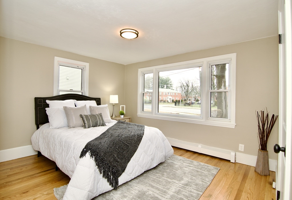 1295 Bay Street Springfield, MA 01109 - Photo 22 of 42 a large bed sitting in a bedroom next to a window