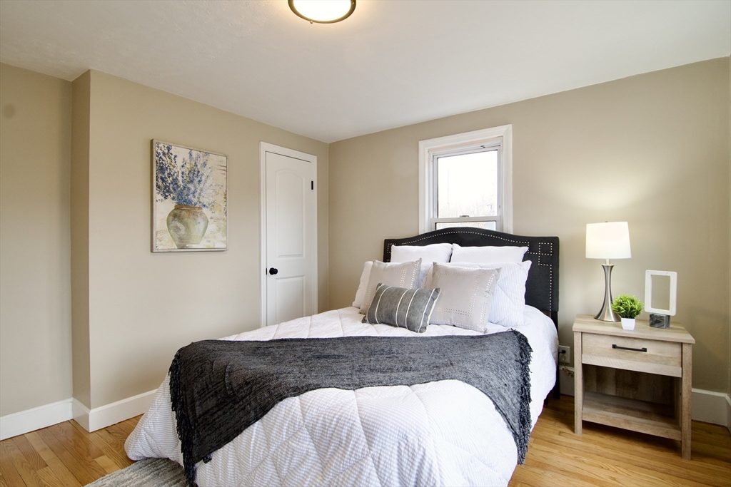 1295 Bay Street Springfield, MA 01109 - Photo 23 of 42 a bedroom with a bed and a lamp
