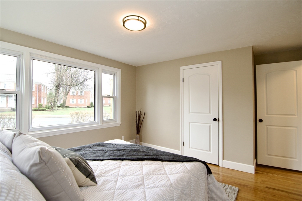 1295 Bay Street Springfield, MA 01109 - Photo 24 of 42 a bedroom with a bed and wooden floor