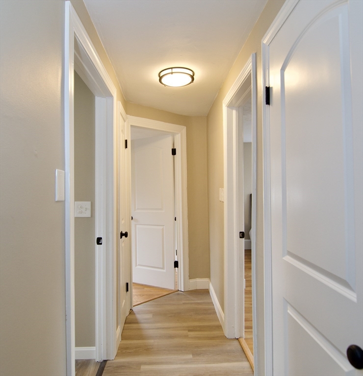 1295 Bay Street Springfield, MA 01109 - Photo 27 of 42 a view of a hallway with wooden floor and a bathroom