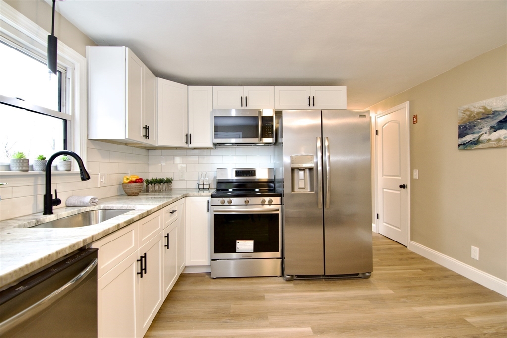 1295 Bay Street Springfield, MA 01109 - Photo 10 of 42 a kitchen with stainless steel appliances granite countertop a refrigerator sink and cabinets