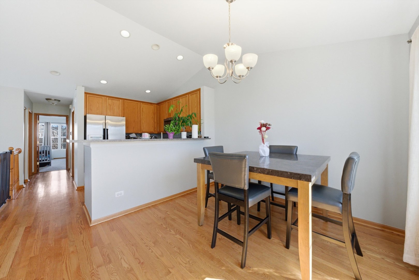 2450 Saddle Ridge Drive Joliet, IL 60432 - Photo 11 of 31 a view of a dining room with furniture and wooden floor