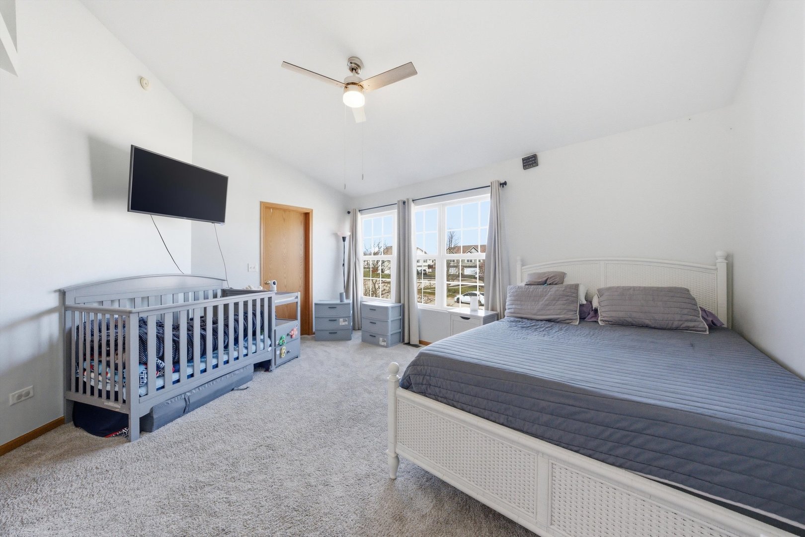 2450 Saddle Ridge Drive Joliet, IL 60432 - Photo 15 of 31 a spacious bedroom with a bed and a chandelier