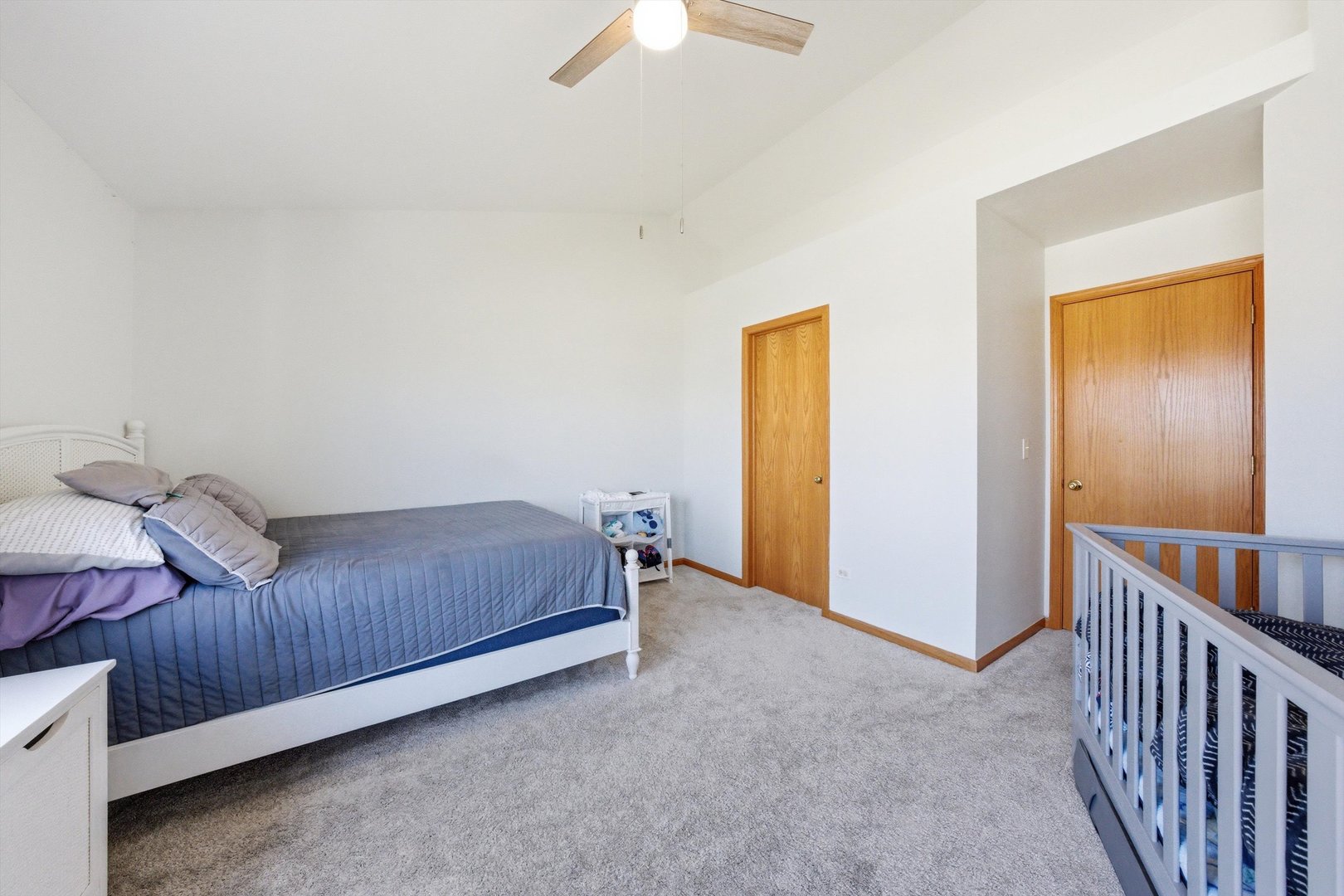 2450 Saddle Ridge Drive Joliet, IL 60432 - Photo 16 of 31 a bedroom with a bed and a chandelier fan