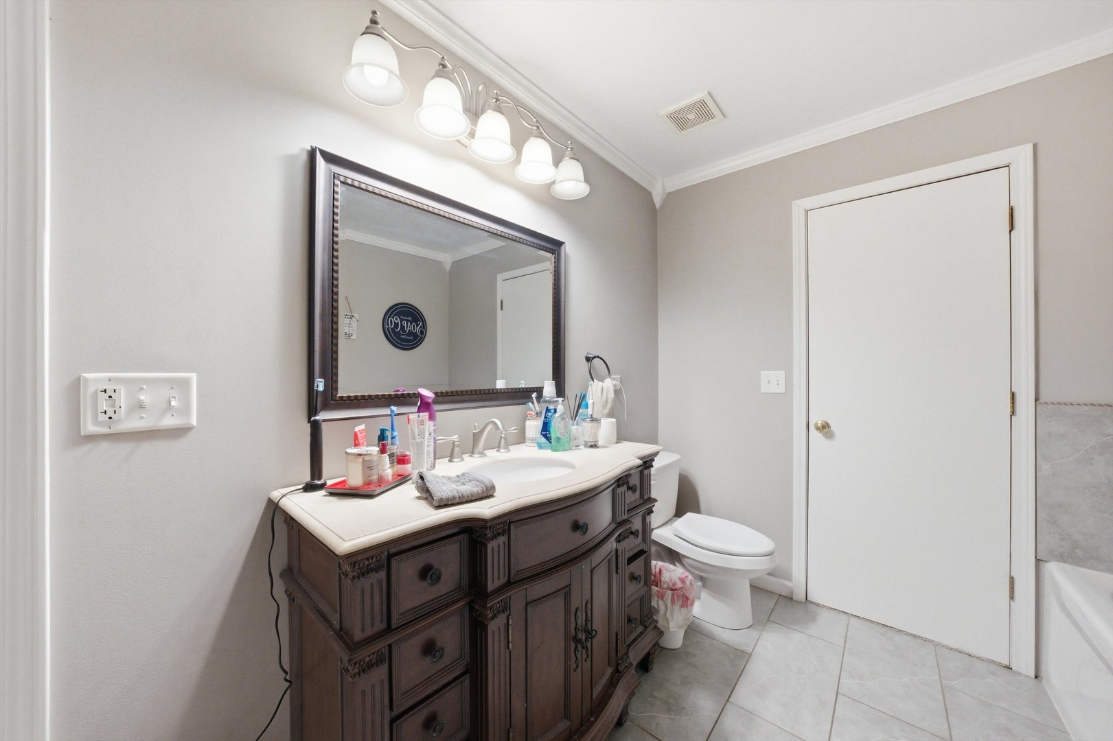 2450 Saddle Ridge Drive Joliet, IL 60432 - Photo 20 of 31 a bathroom with a toilet sink and mirror