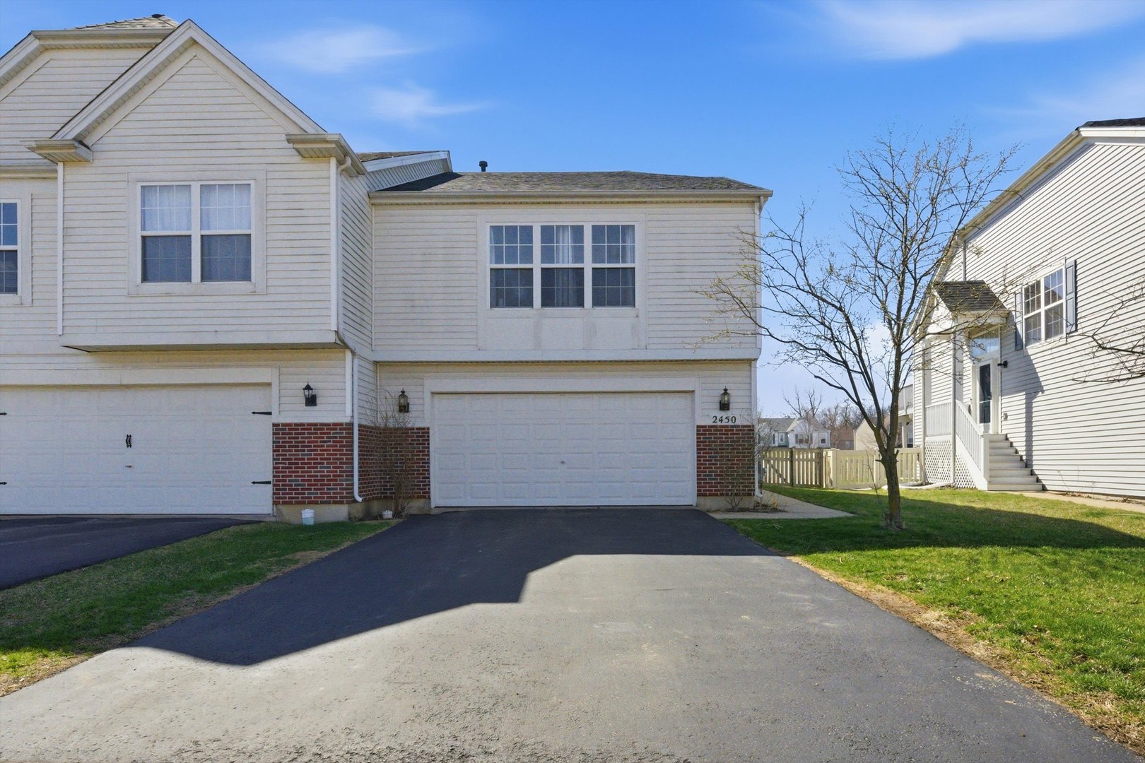 2450 Saddle Ridge Drive Joliet, IL 60432 - Photo 4 of 31 a front view of a house with a yard and a garage