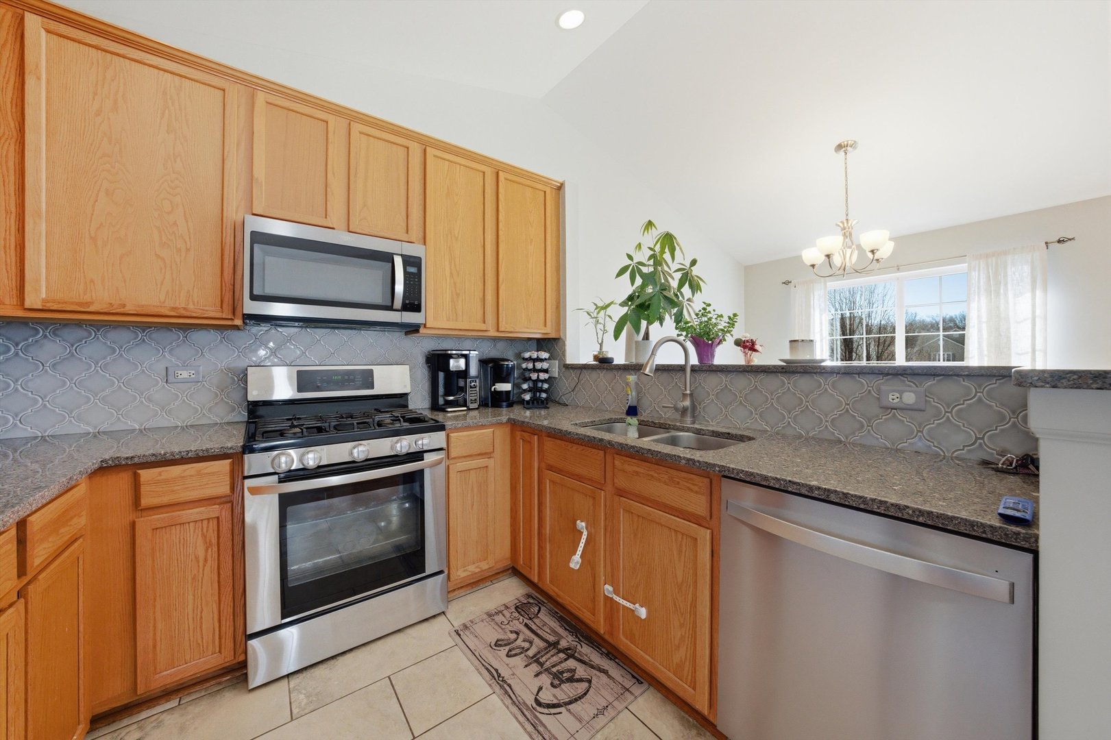 2450 Saddle Ridge Drive Joliet, IL 60432 - Photo 9 of 31 a kitchen with stainless steel appliances granite countertop a sink stove and microwave