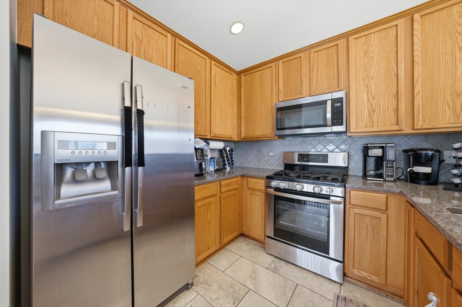 2450 Saddle Ridge Drive Joliet, IL 60432 - Photo 10 of 31 a kitchen with stainless steel appliances granite countertop a refrigerator a stove top oven a sink and dishwasher
