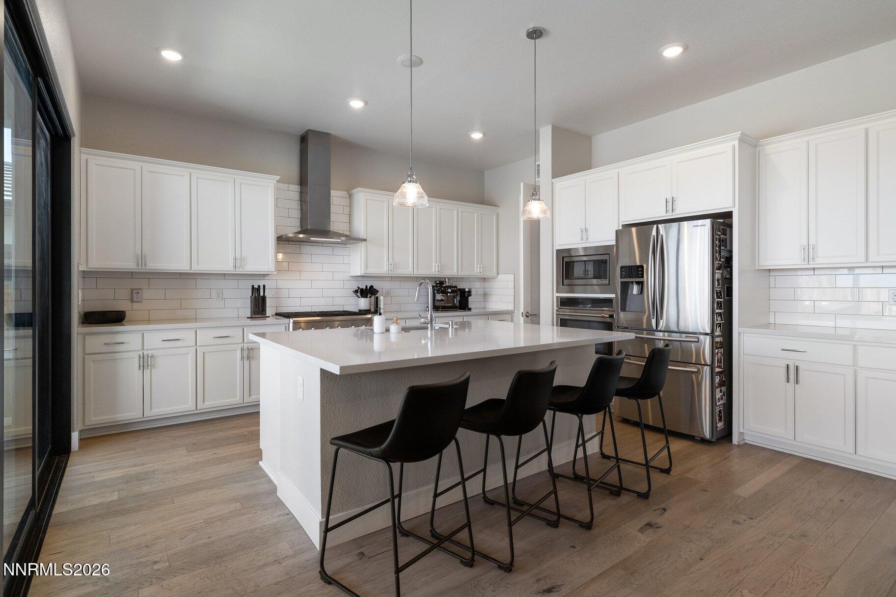 911 Solarium Drive Reno, NV 89511 - Photo 11 of 37 a kitchen with kitchen island granite countertop wooden cabinets and refrigerator