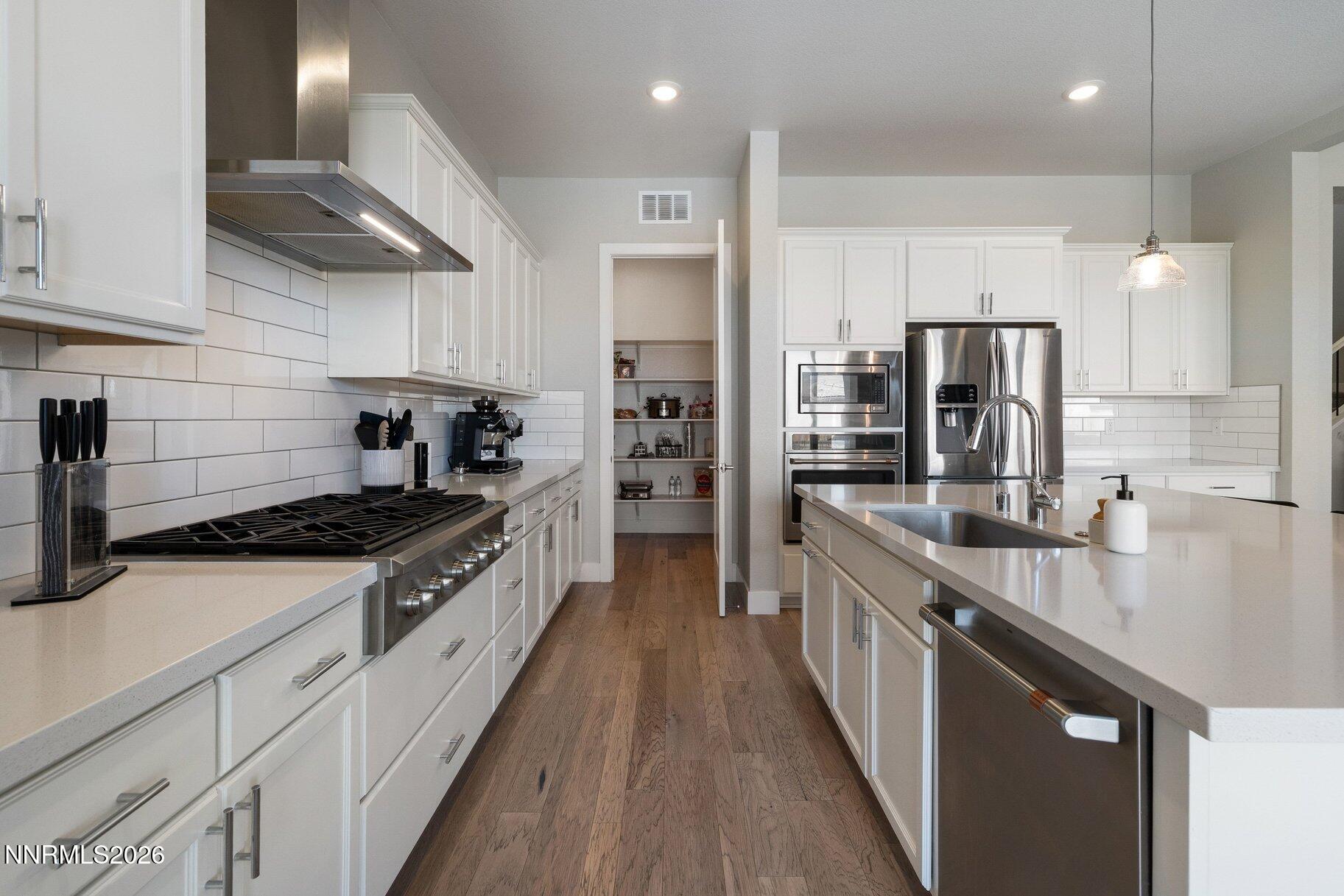 911 Solarium Drive Reno, NV 89511 - Photo 12 of 37 a large kitchen with stainless steel appliances granite countertop a stove a sink and a refrigerator