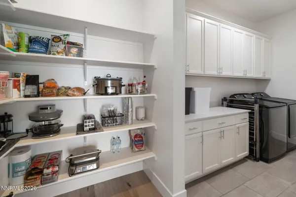 a kitchen with white cabinets and white appliances
