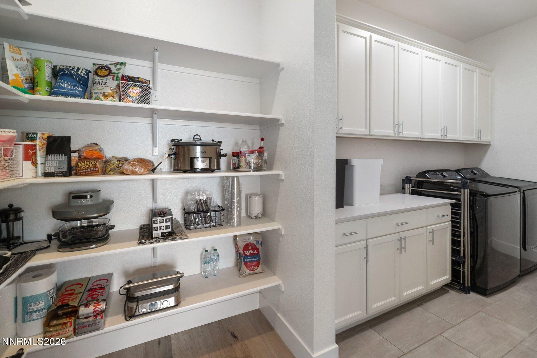 911 Solarium Drive Reno, NV 89511 - Photo 14 of 37 a kitchen with white cabinets and white appliances