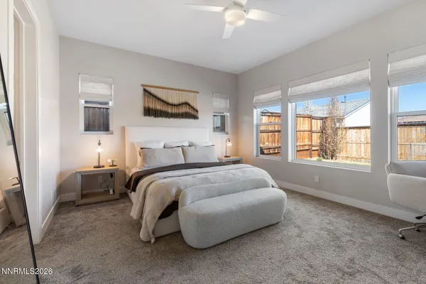 a spacious bedroom with a bed and window