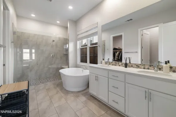 a spacious bathroom with a double vanity sink mirror and double