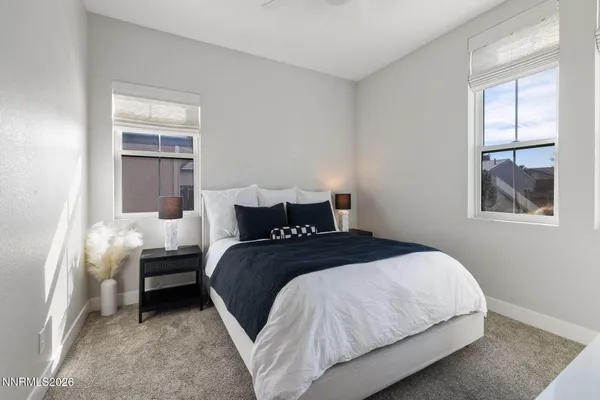 a bedroom with bed and window