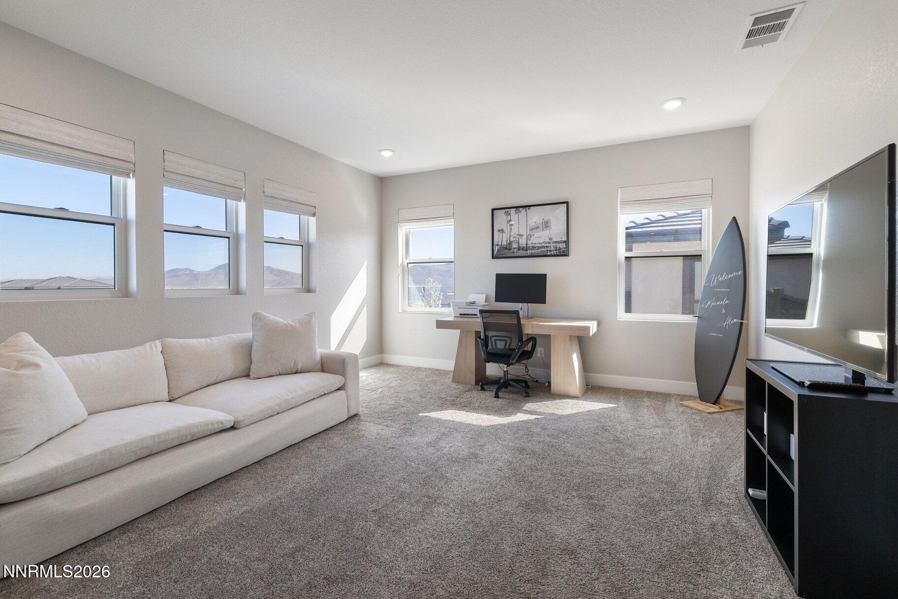 911 Solarium Drive Reno, NV 89511 - Photo 25 of 37 a living room with furniture and a flat screen tv