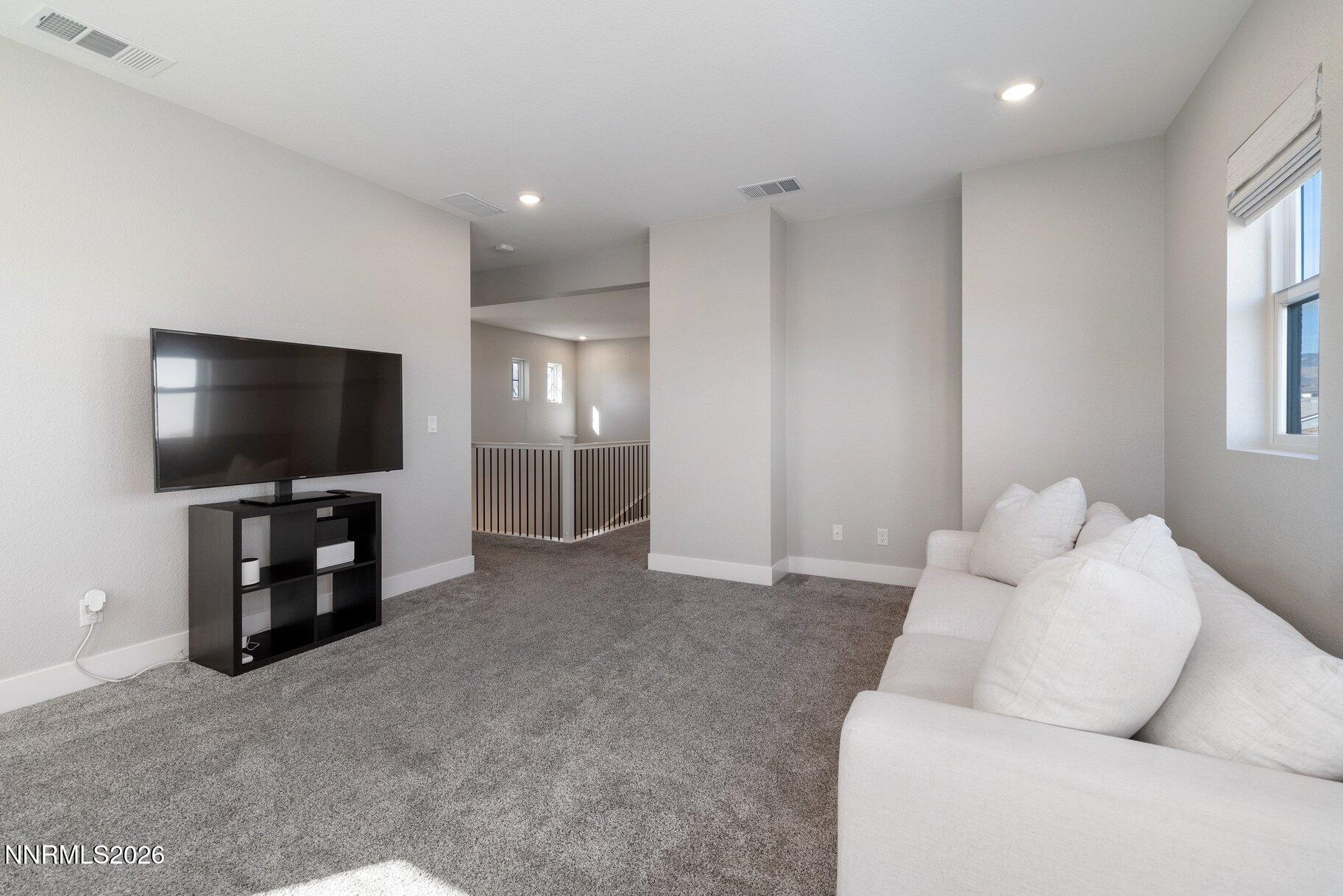 911 Solarium Drive Reno, NV 89511 - Photo 26 of 37 a living room with furniture and a flat screen tv