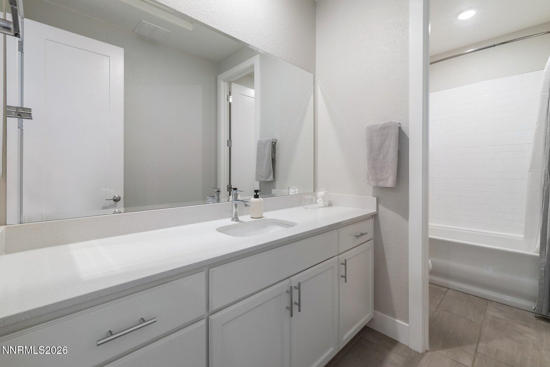 911 Solarium Drive Reno, NV 89511 - Photo 27 of 37 a bathroom with a sink and a mirror