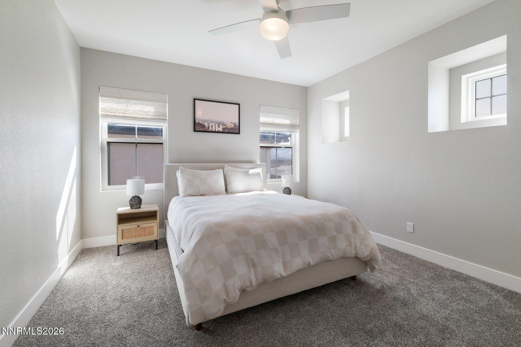 911 Solarium Drive Reno, NV 89511 - Photo 28 of 37 a bedroom with a bed and a chandelier