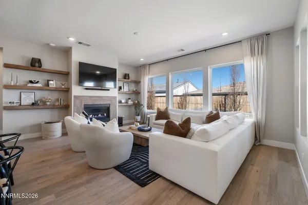 a living room with furniture a fireplace and a flat screen tv
