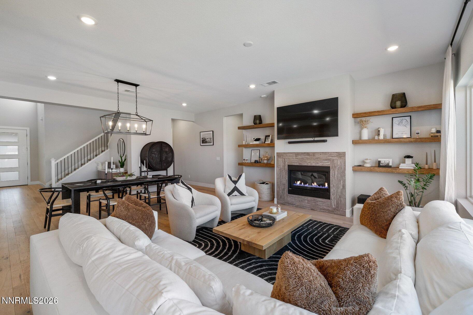 911 Solarium Drive Reno, NV 89511 - Photo 7 of 37 a living room with furniture a flat screen tv and a fireplace