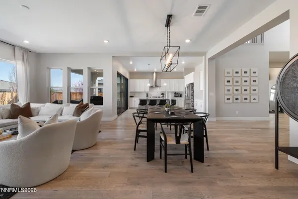 a large kitchen with a table and chairs