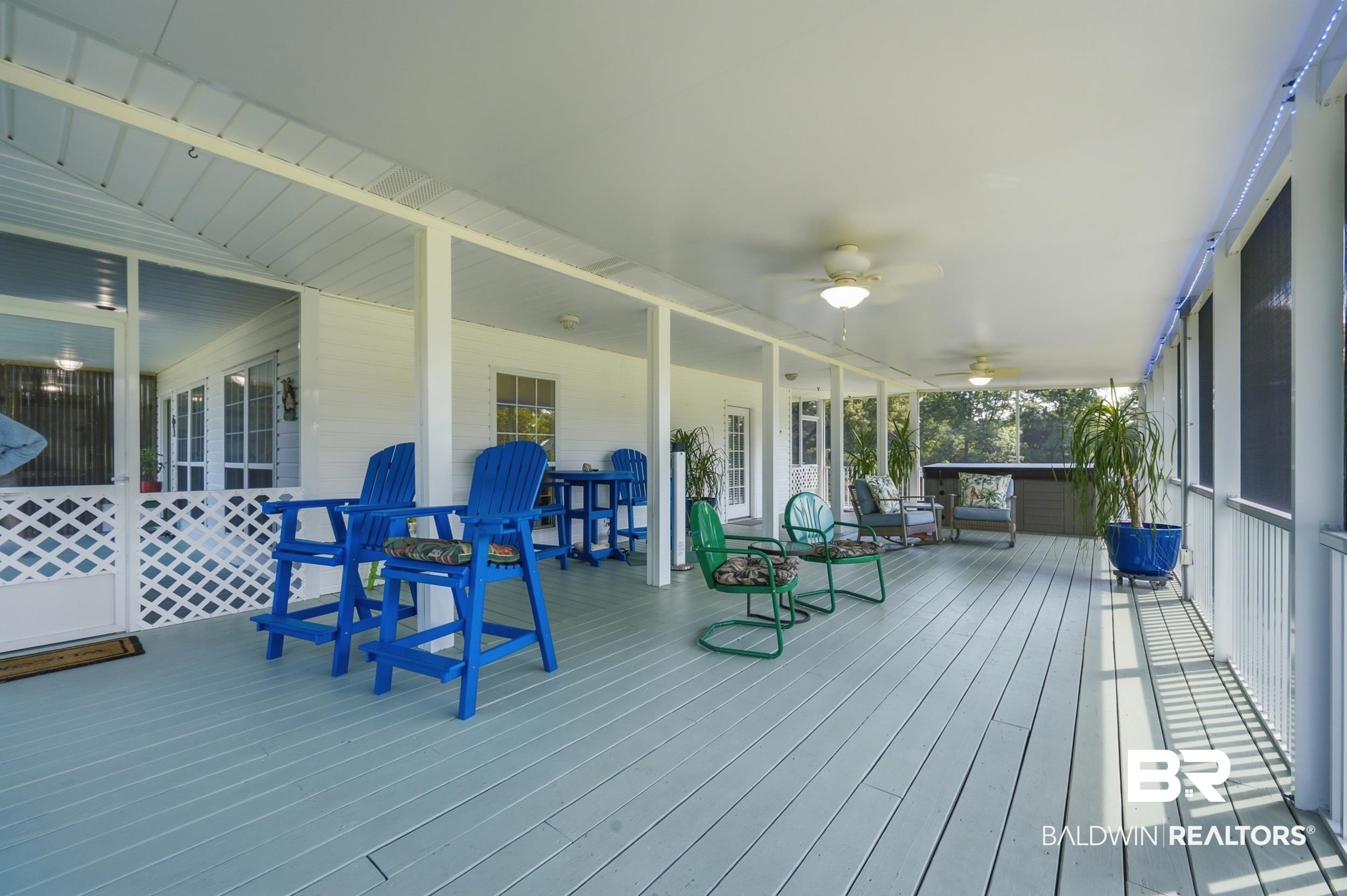 15855 Calvin Richerson Road Bay Minette, AL 36507 - Photo 14 of 83 Expansive screened porch with light blue wood-finish decking, multiple ceiling fans, and overhead lighting