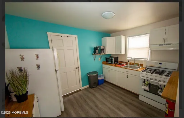 a kitchen with a refrigerator and a stove