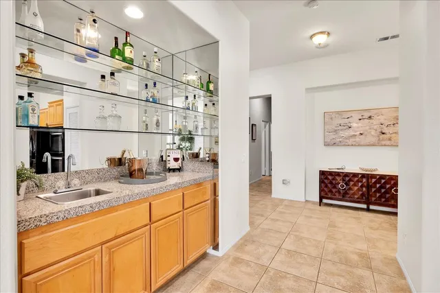 a kitchen with stainless steel appliances kitchen island granite countertop a table chairs and a view of living room