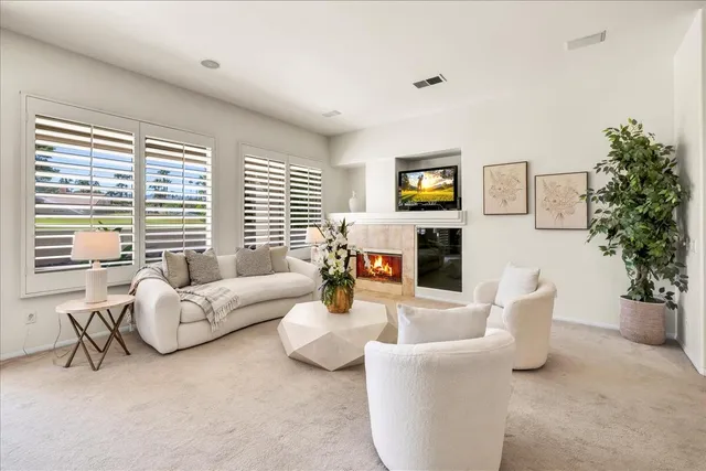 a kitchen with a sink a counter top space and living room