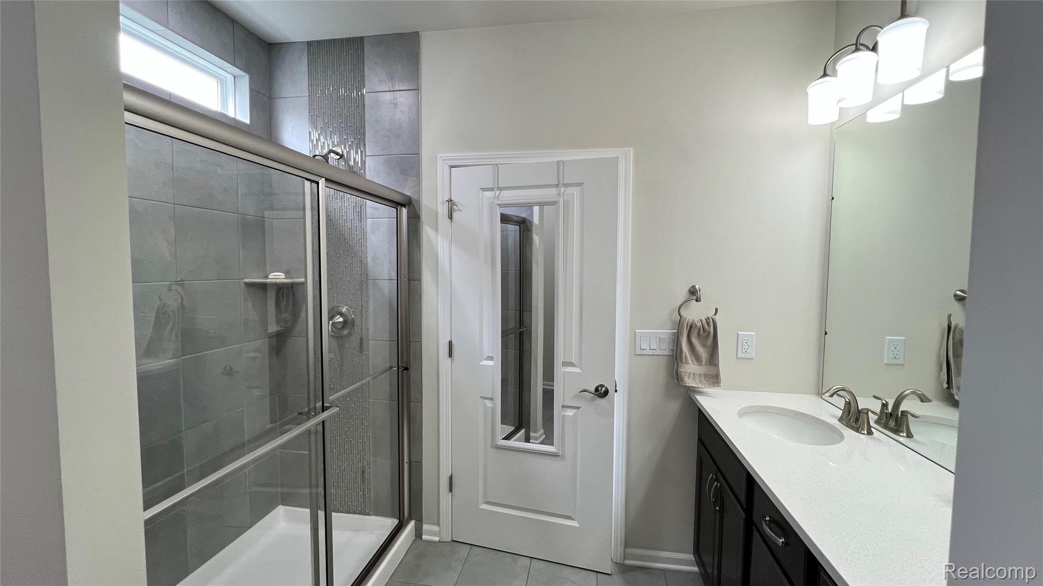 50192 Ogden Road Canton, MI 48188 - Photo 21 of 28 Full bath with vanity, a shower stall, and light tile patterned floors