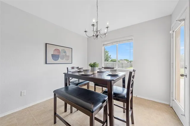 a view of a dining room with furniture and a chandelier