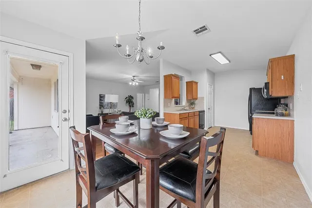 a view of a dining room with furniture and a chandelier