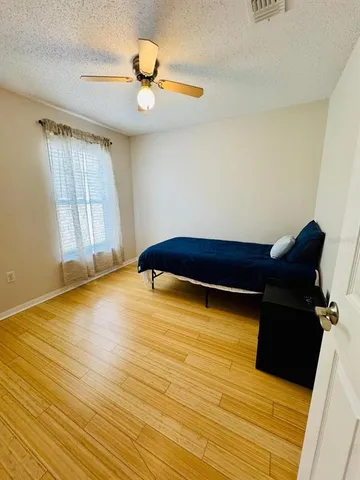 a room with wooden floor and a window