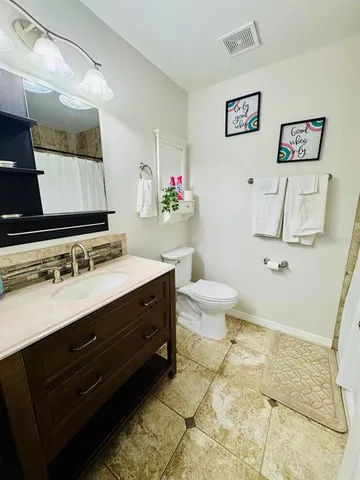 a spacious bathroom with a sink and a mirror